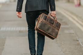Man carrying laptop in bag.