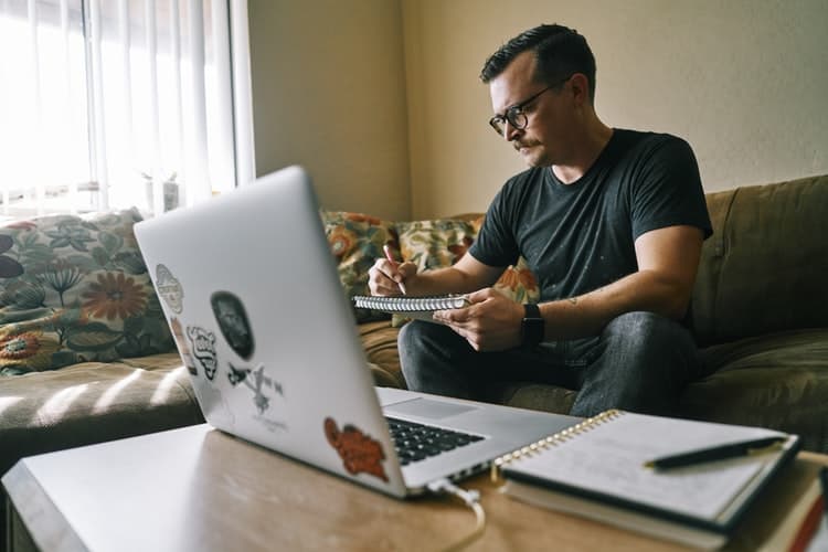 Man using his laptop for remote work at home