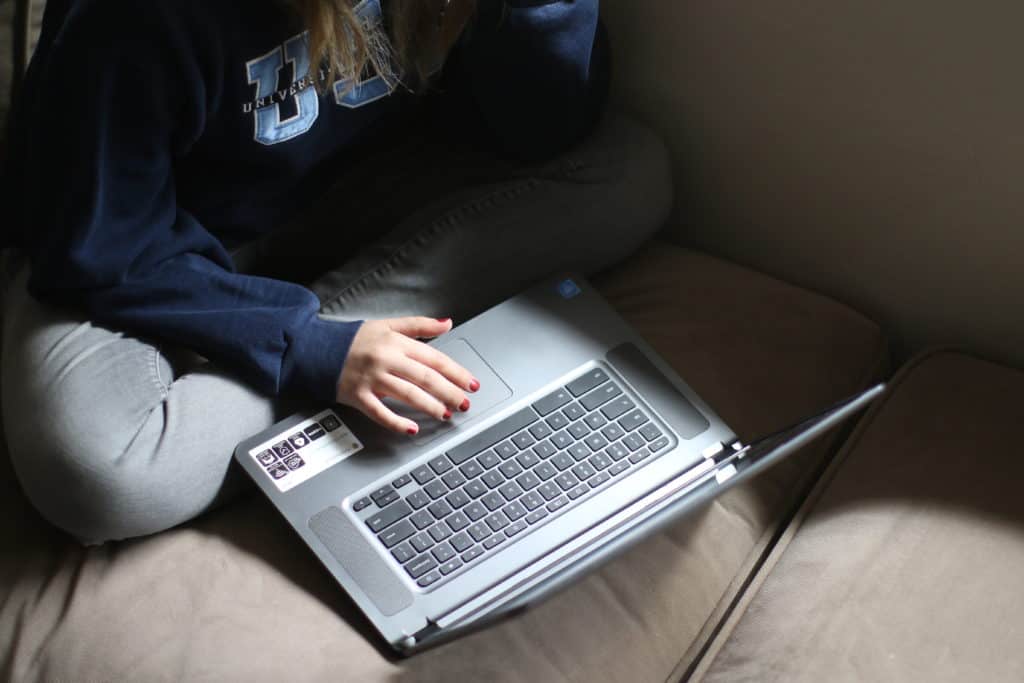 A mechanical engineering student typing in her laptop