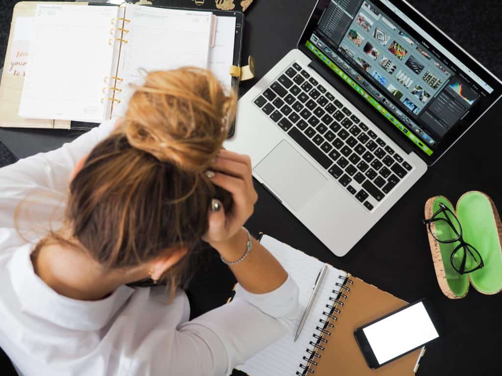 Woman with her hand in her head wondering how to make her laptop last longer
