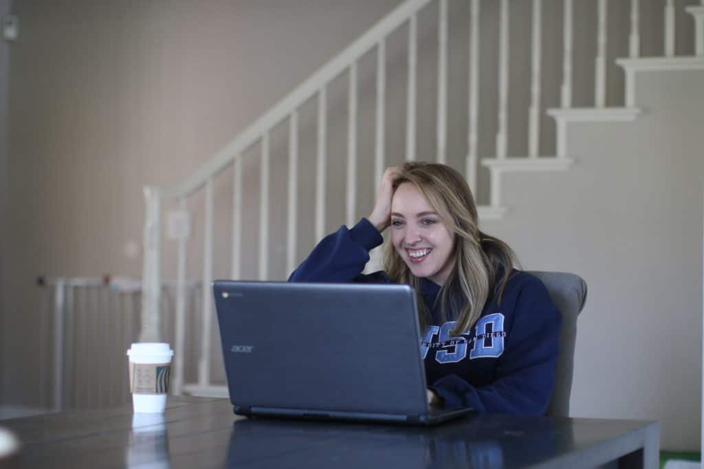 College student using her laptop at home