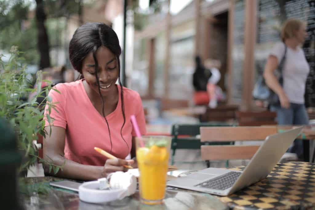 A woman sitting with her laptop on the table