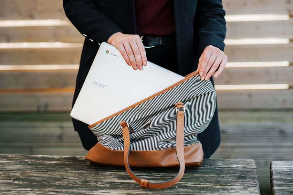 Woman putting a laptop in a bag
