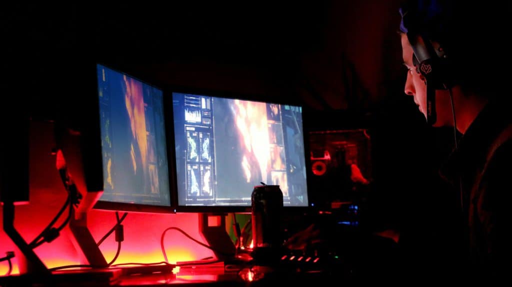 A gamer enjoying his multiple monitors