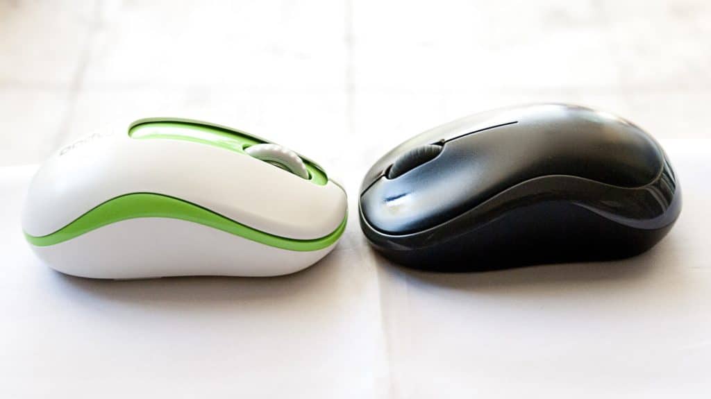 Two wireless mouse facing each other