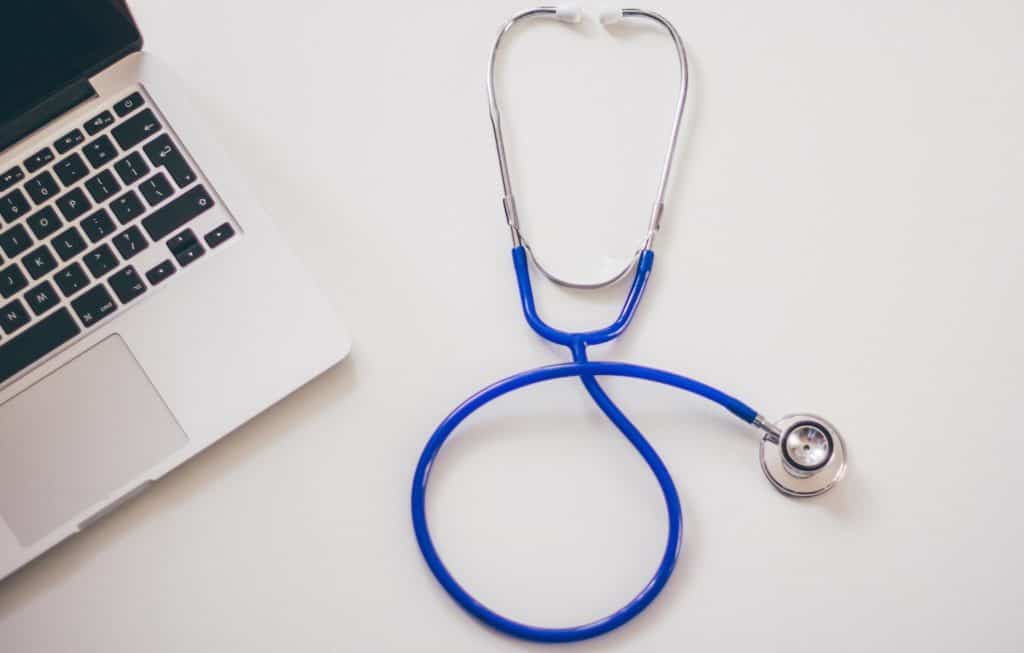 Stethoscope placed beside a laptop 