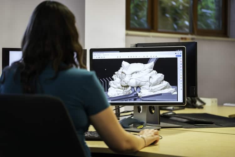 Woman looking at her computer monitor after creating a 3d image