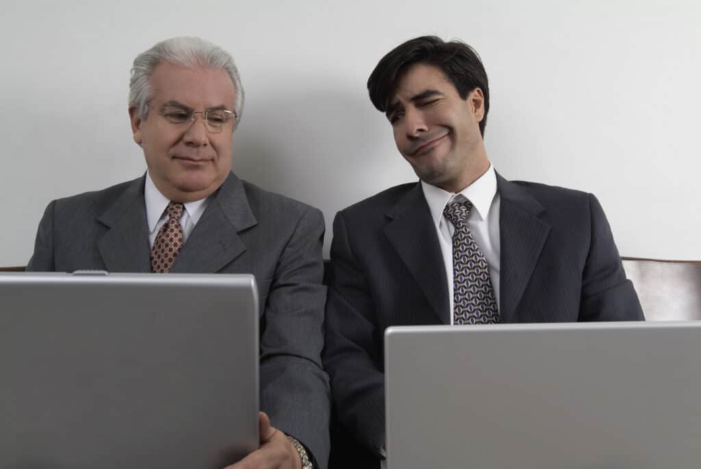 Two men comparing Acer vs Asus laptops