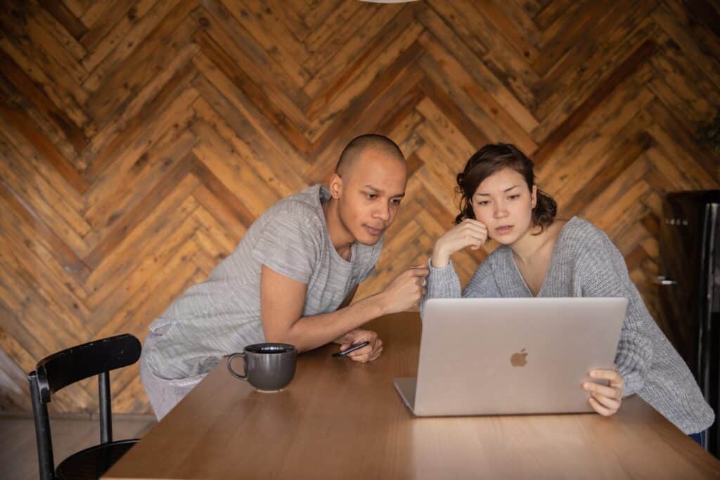 Couple using a Firestick to stream a show on their laptop