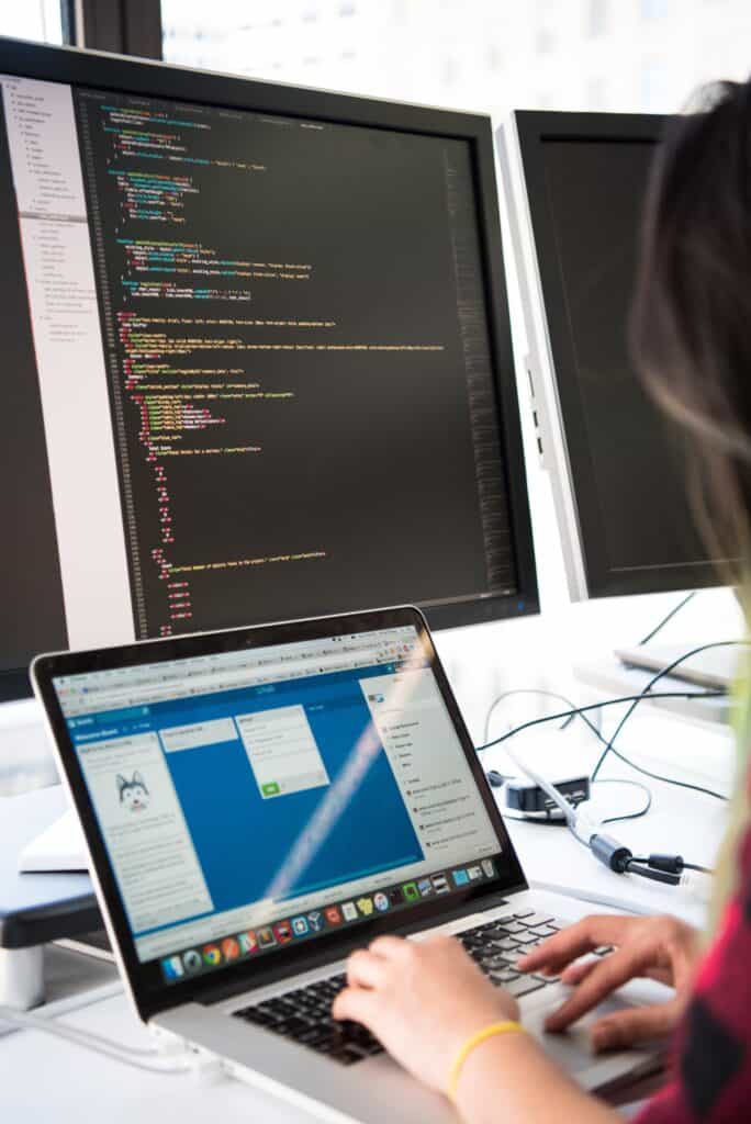 Woman using 3 monitors