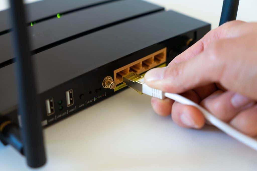 ethernet cable plugging into a black router